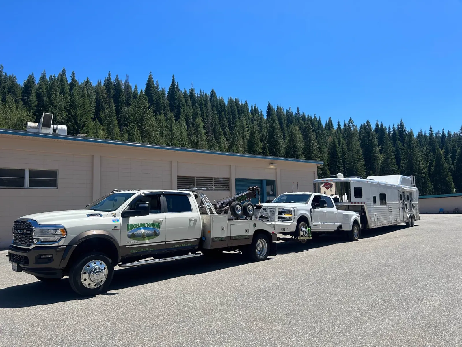 Ridgeline Towing wrecker towing a dually pickup with a horse trailer in Gold Run, California